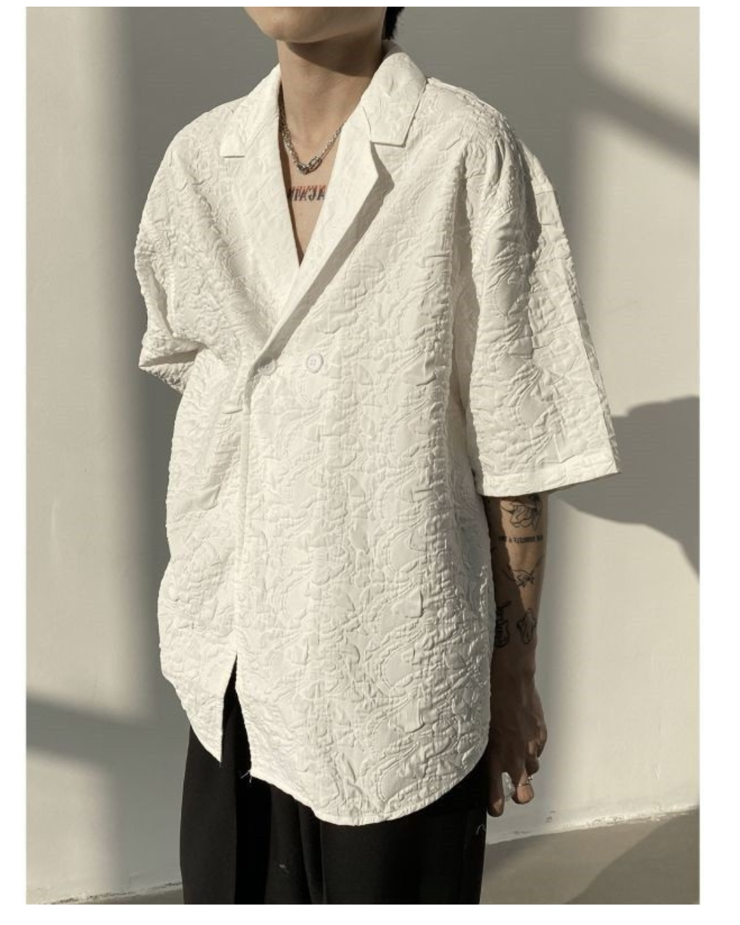 12_c16fb0ca-e130-4931-af61-3515df1db828 Asymmetric Button Embossed Pattern Loose Short Sleeve Shirt - Image 1